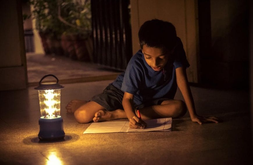 Child works by solar lamp