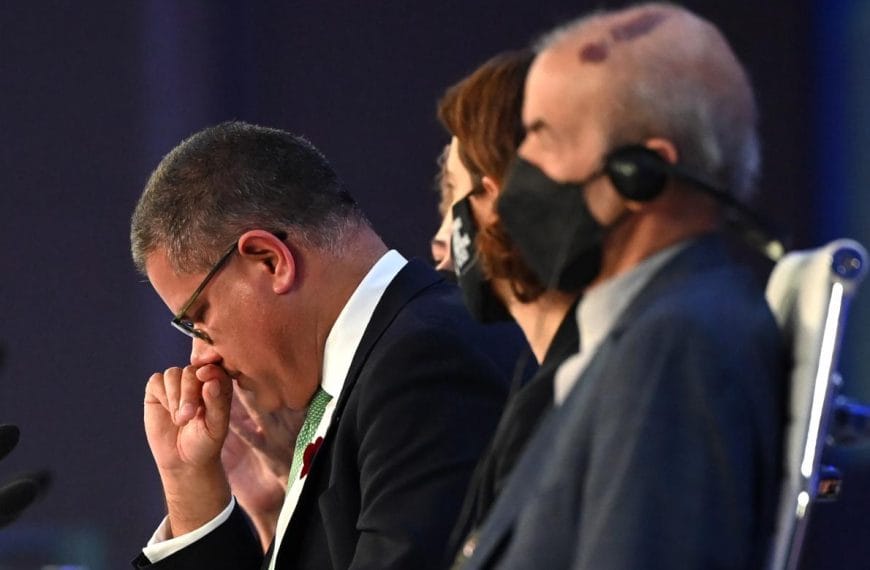 Alok Sharma sits in a row of people at COP26