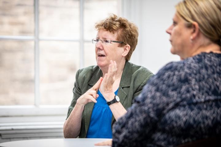 Members of staff converse in BSL