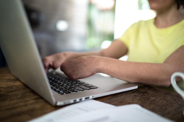a close up of a persons hands on a keyboard