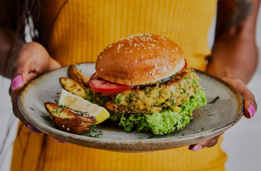 Chef holding vegan burger.