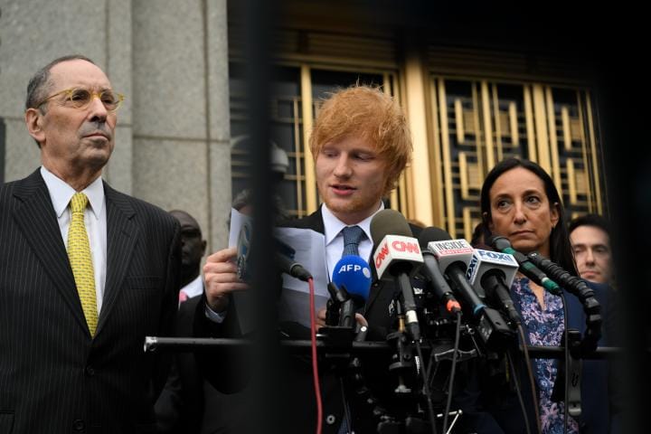 Ed Sheeran and lawyers speak in front of microphones outside court