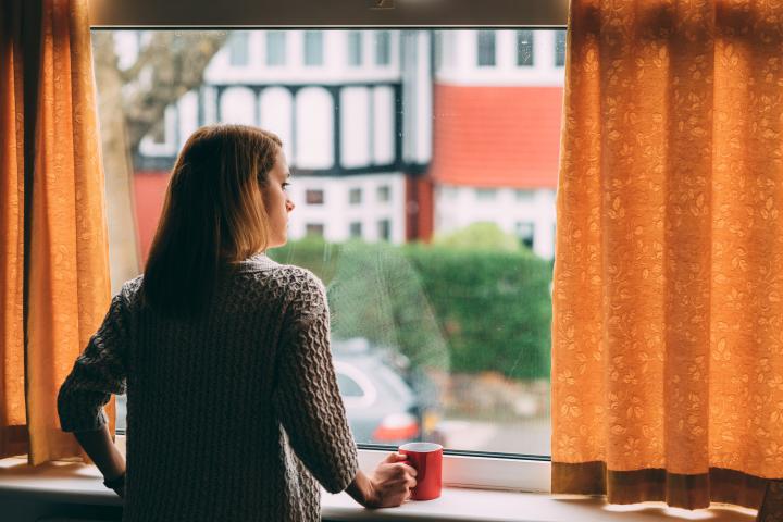 Woman looks out at empty city