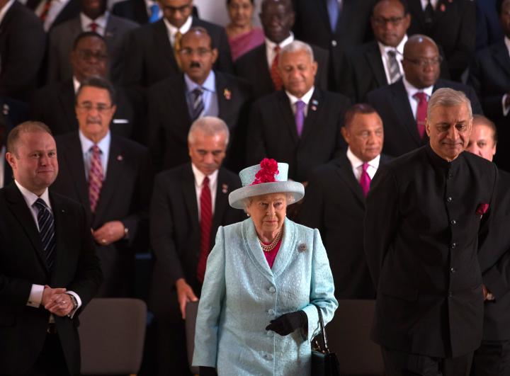 Queen Elizabeth II leaves with Commonwealth Secretary General Kamalesh Sharma, (R) following the family photograph at the CHOGM opening ceremony at the Mediterranean Conference Centre on November 27, 2015 near Valletta, Malta.