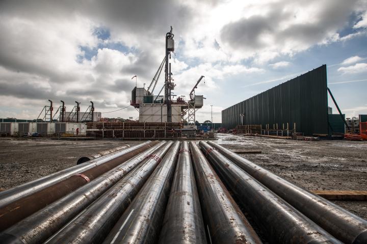 Pipes lie in front of fracking well
