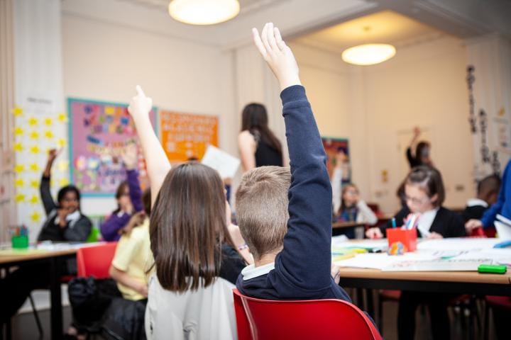 School pupils participating in class