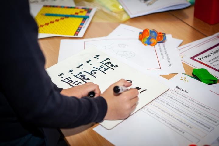 school pupil working in a classroom