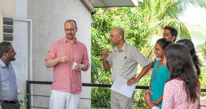 Image shows Michael Eddleston standing around a group of his colleagues.