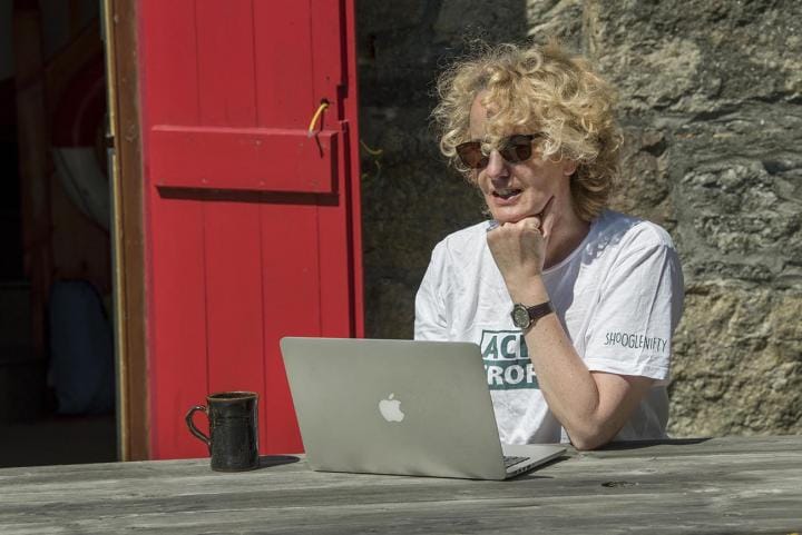 student at computer outside