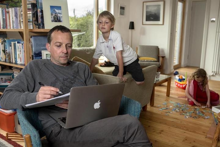 Student at computer with kids
