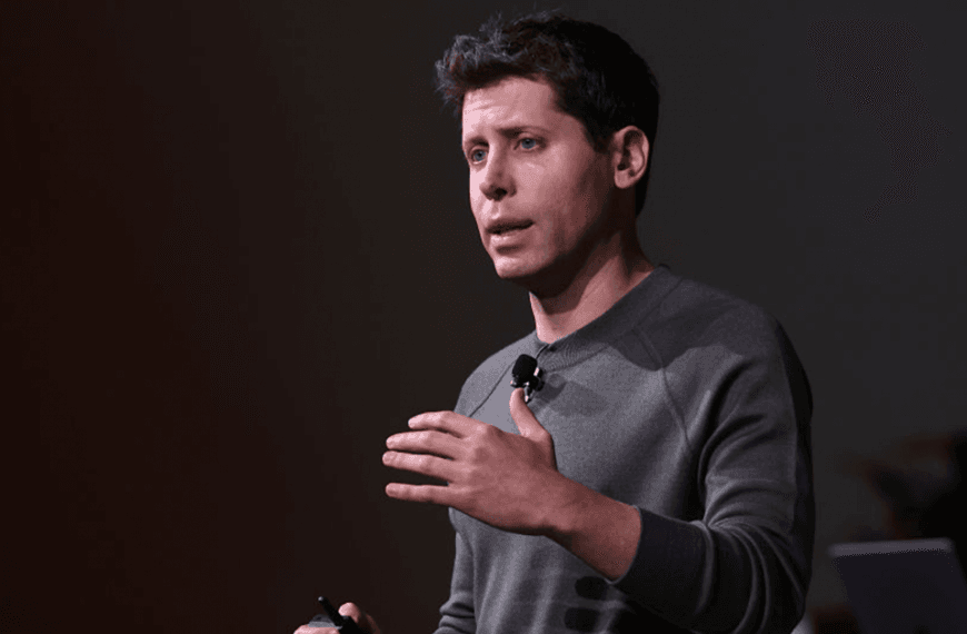 OpenAI CEO Sam Altman on stage talking to an audience.