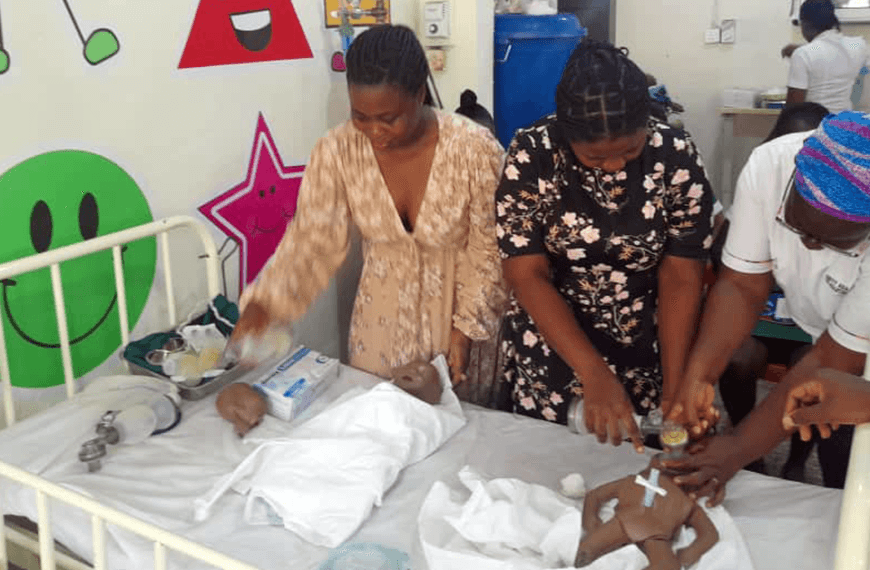 A nurse using a doll as a demonstration to her staff at a hospital in Ghana.