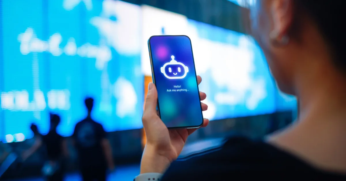 A person looking at their phone, displaying an AI chatbot.