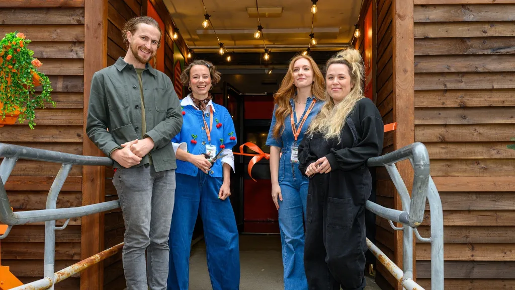 Producer Francesca Moody with members of her team standing outside the entrance to the Shedinburgh venue. 