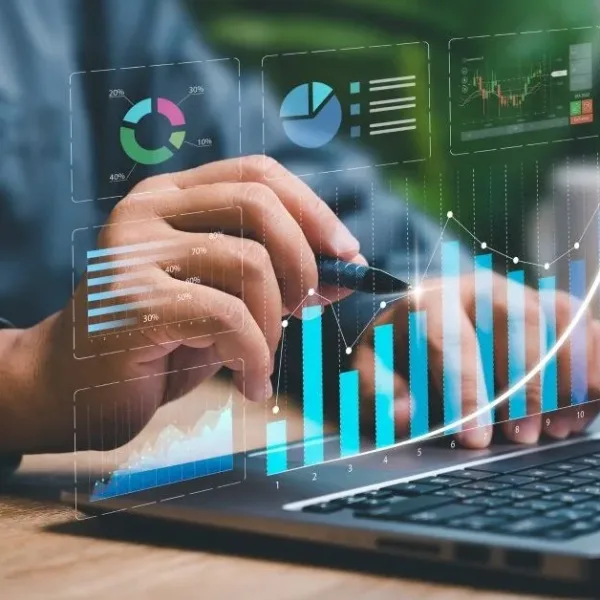 Business person looking at graphs on a laptop