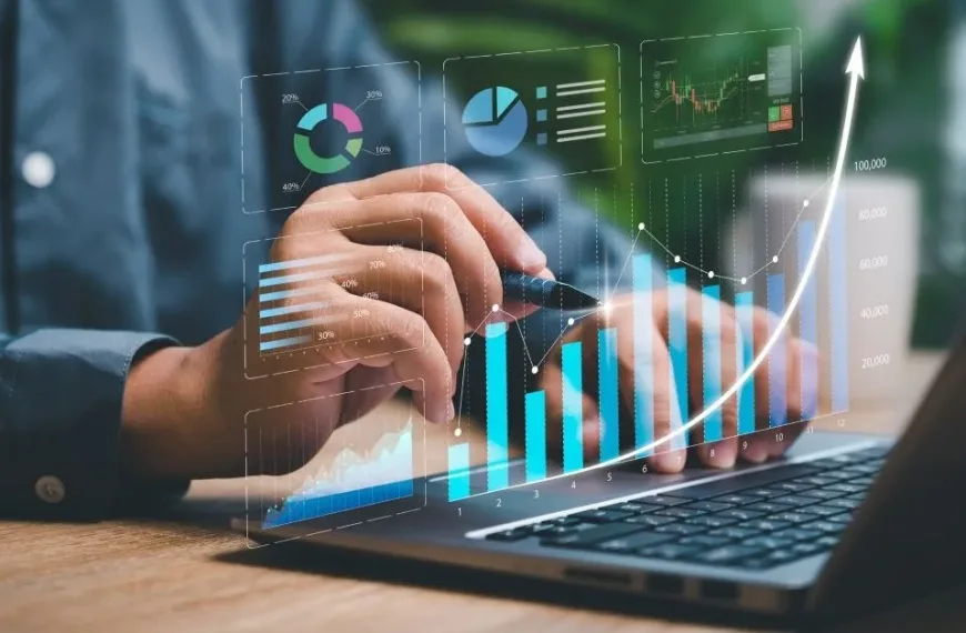 Business person looking at graphs on a laptop