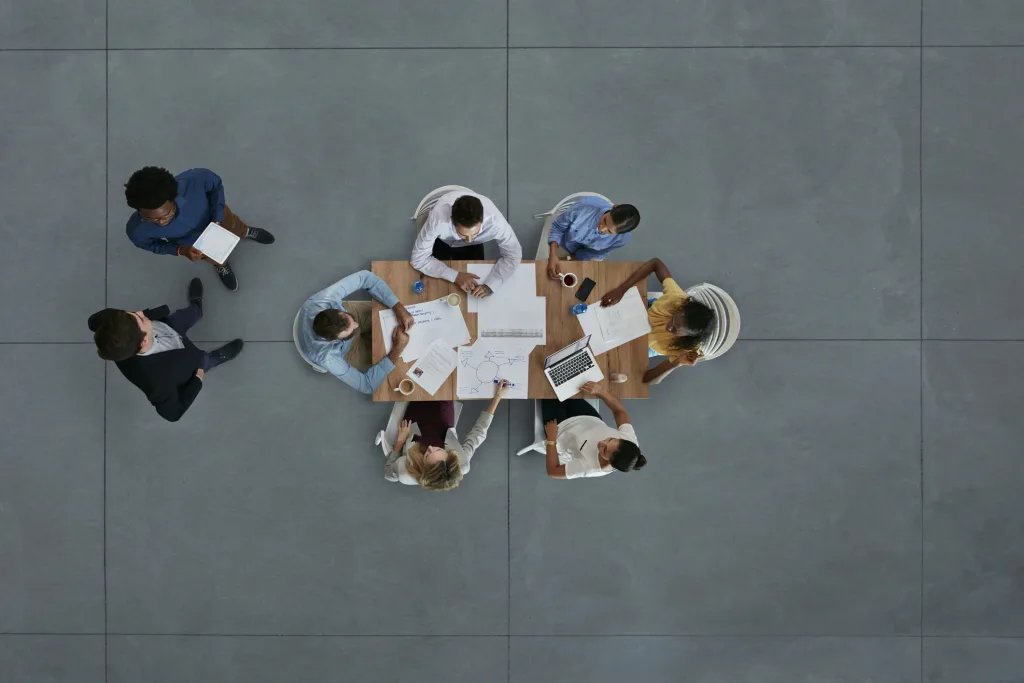 A group of people having a business meeting around a table.