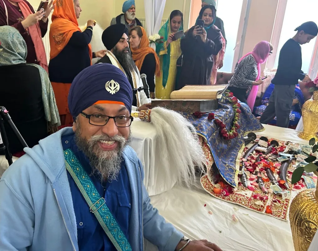 Members of the Community viewing the Guru Granth Sahib at Edinburgh Gurdwara.