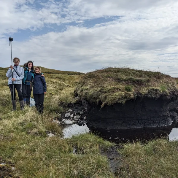(L-R) Tilda Tarrant, Rachel Orchard and Mareike Feldmann pose for a photo on boggy terrain at Ardtornish Estate, Morvern