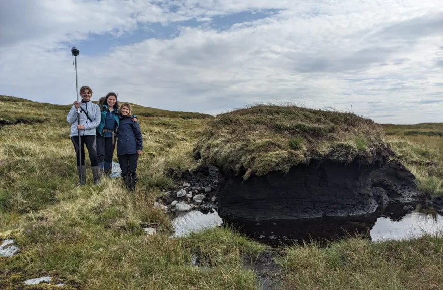 (L-R) Tilda Tarrant, Rachel Orchard and Mareike Feldmann pose for a photo on boggy terrain at Ardtornish Estate, Morvern