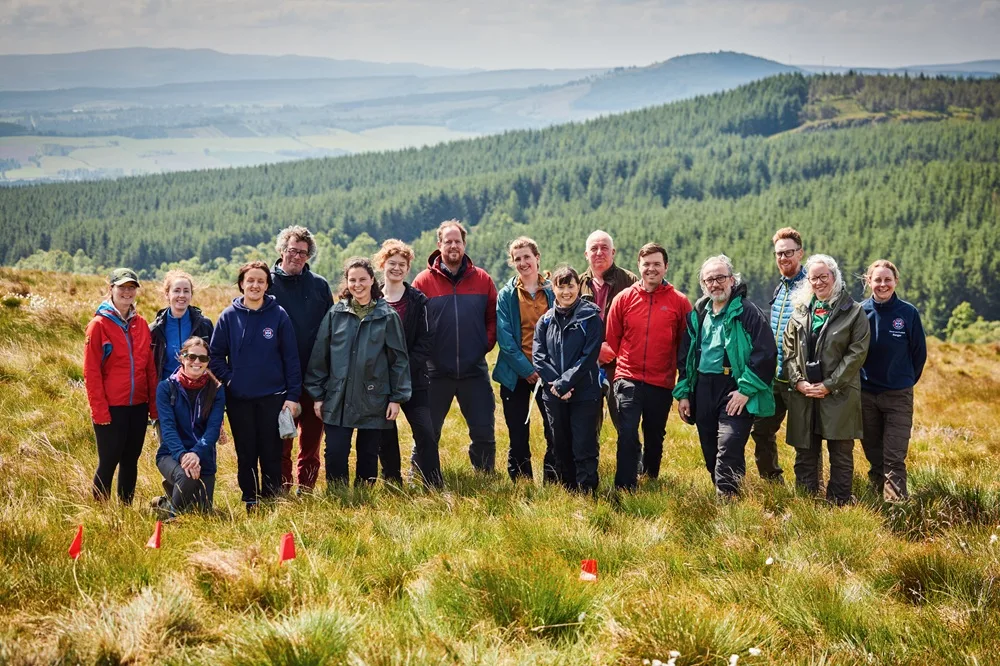 Forest and Peatlands PhD students and supervisors (L-R) Prof Caroline Nichol, Prof Marc Metzger, Rachel Orchard, Mareike Feldmann, Prof Rob Ogden, Tilda Tarrant, Dr Nicholle Bell, Dr Iain McNicol, Dr Georgios Xenakis, Dr Annie Yang pose for a photo on moorland at Drumbrae, Stirlingshire