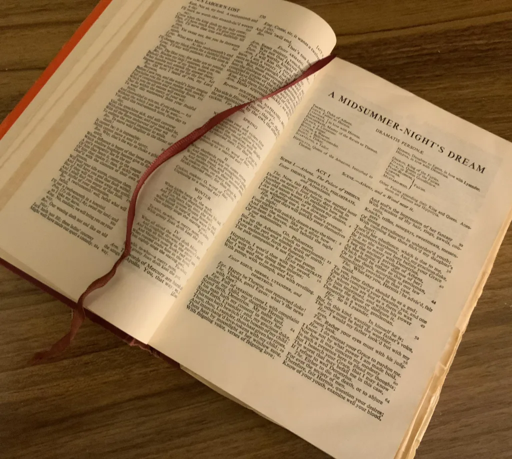 The photograph is of a hard back copy of The Complete Works of Shakespeare, lying open at the page where the play A Midsummer Night's Dream begins. It illustrates the quotation from the play, provided as the interviewee's favourite written quotation. There is a ribbon marking the place in the book.