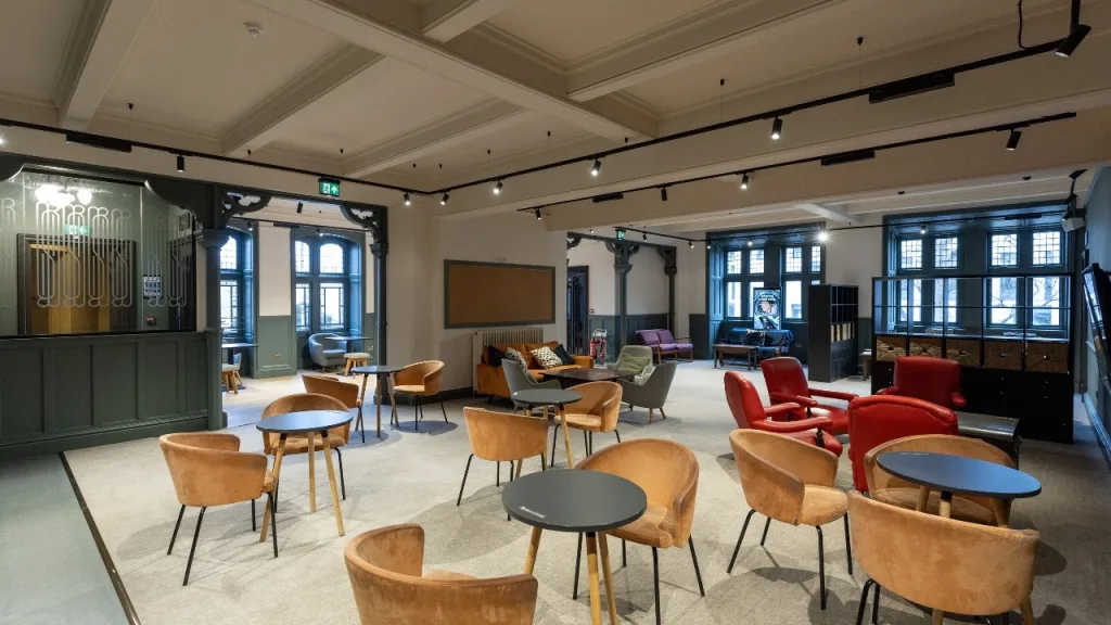 An interior view of The Lounge, a relaxed space for students, featuring couches, arm chairs and soft furnishings. 