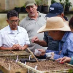 A group of people at the El Pacífico neighbourhood forest nursery project.