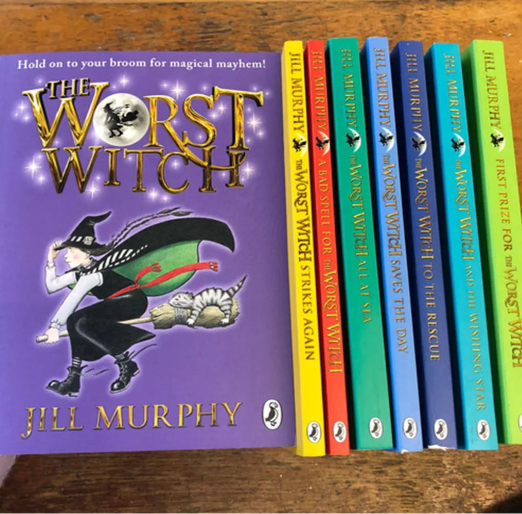 This image shows a photograph of colourful children's books, called The Worst Witch series by the author Jill Murphy. The books are laid out to show the front cover design of the first book in the series and the others are lined up next to it with their spines showing outwards.