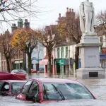 A car on a street half submerged in water