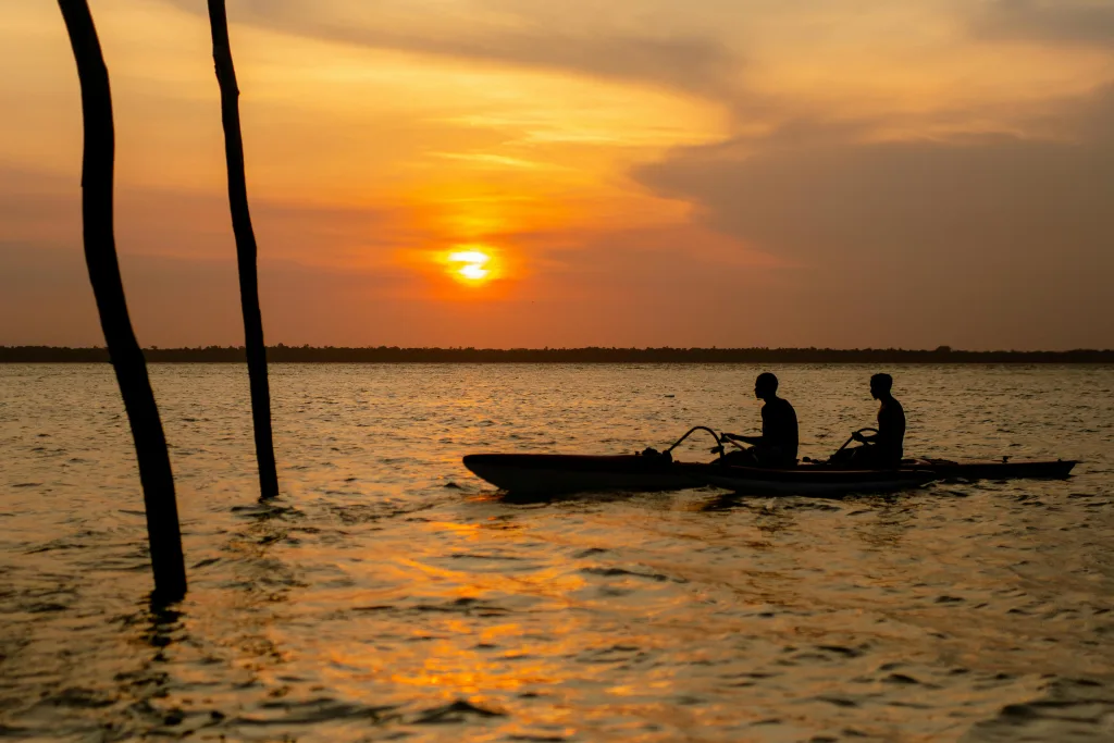 Two people in a boat during sunset in Belém in Brazil