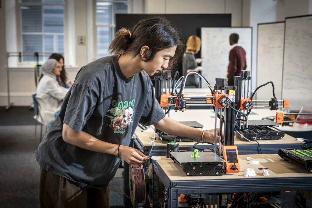 Student working with a 3D printer.