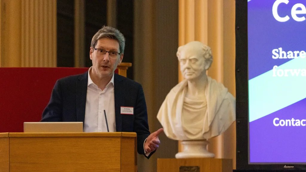 Deputy Vice Principal International and Director of Edinburgh Global, Alan Mackay pictured giving a speech at a lectern during an Education Beyond Borders event.