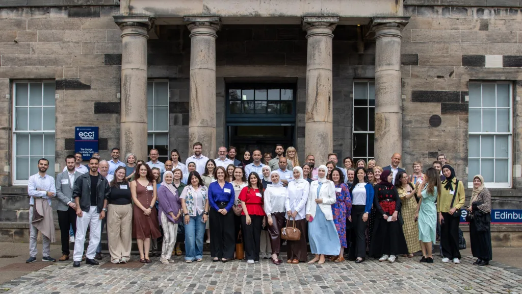 A group of people including scholars, students and partners from the Higher Education Scholarships for Palestinians (HESPAL) programme are pictured outside a University building during the HESPAL annual gathering in June 2026.