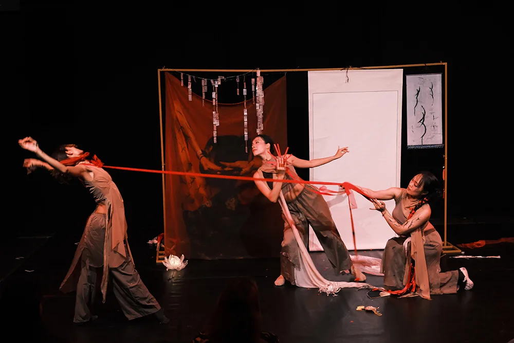 Jiayi Chen, Rubi Yang and Rubi Rao dance on stage performing Nüshu at the Edinburgh Fringe 2026 