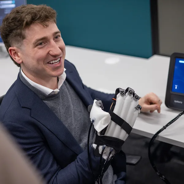 Rowan Armstrong, founder of student startup Bioliberty, demonstrates the Lifeglov wearable medtech