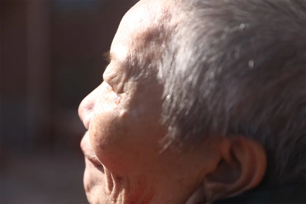 A close up of Jiayi's grandma face and a tear.