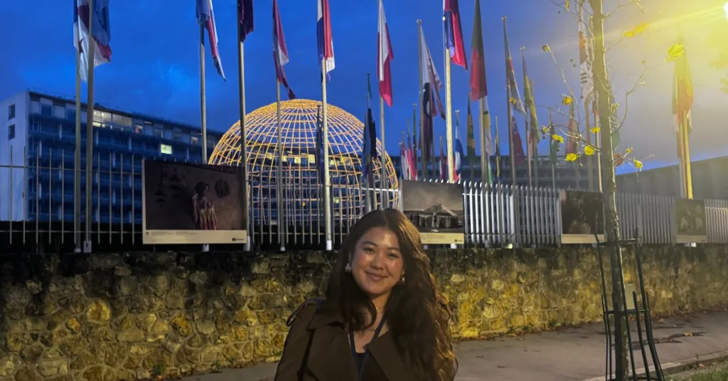 A person standing outside the United Nations building in Geneva