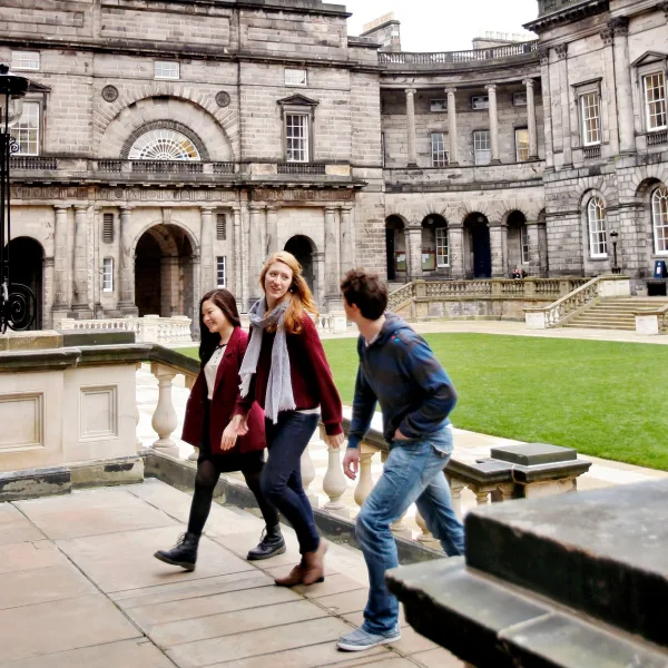 Three students walking up the steps in Old College Quad, Edinburgh. Image credit: Paul Dodds