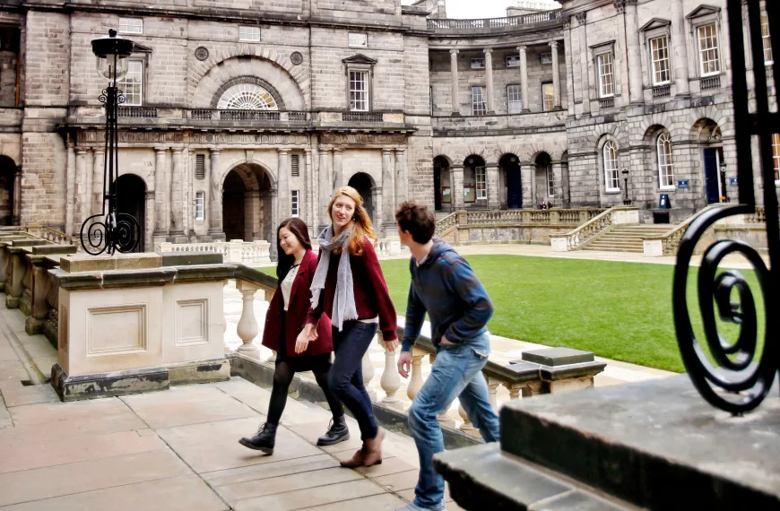 Three students walking up the steps in Old College Quad, Edinburgh. Image credit: Paul Dodds