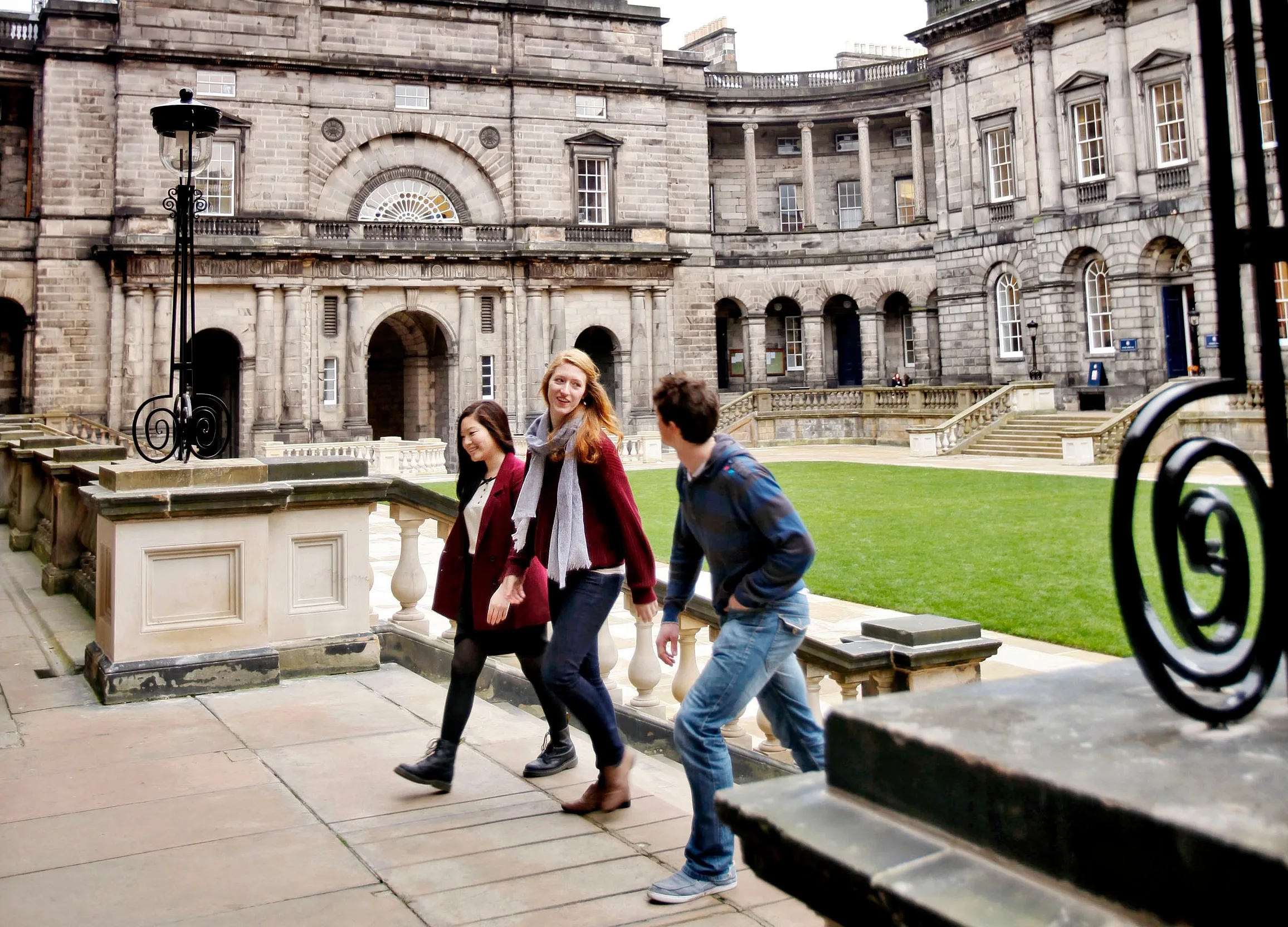 Three students walking up the steps in Old College Quad, Edinburgh. Image credit: Paul Dodds
